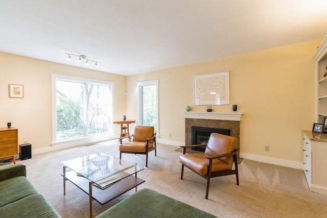 3312 Oakland St, Ames, IA 50014 - living area featuring a glass covered fireplace, light carpet, and baseboards