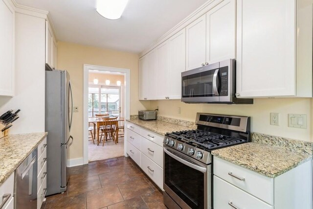 3312 Oakland St, Ames, IA 50014 - kitchen with appliances with stainless steel finishes, white cabinetry, and light stone counters