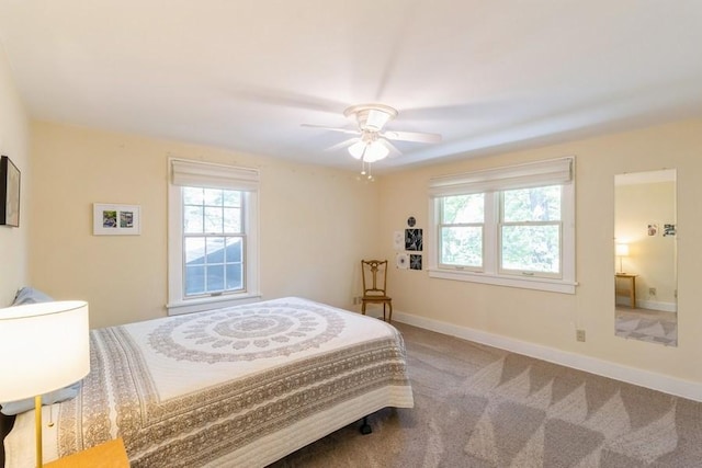 3312 Oakland St, Ames, IA 50014 - bedroom with multiple windows, baseboards, ceiling fan, and carpet floors