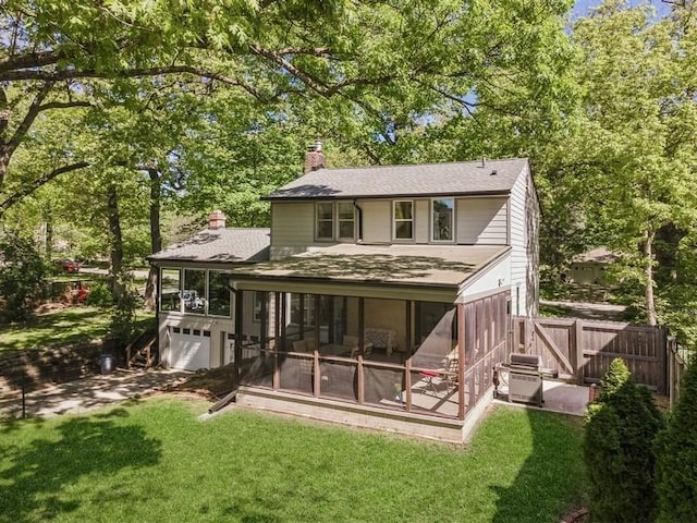3312 Oakland St, Ames, IA 50014 - back of house with a sunroom, a chimney, an attached garage, and a shingled roof