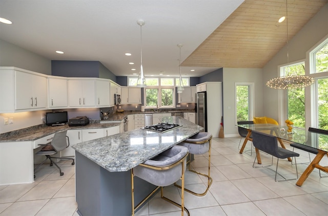 14943 Holcomb Ave, Clive, IA 50325 - kitchen featuring appliances with stainless steel finishes, plenty of natural light, a kitchen island, recessed lighting, and light tile patterned floors