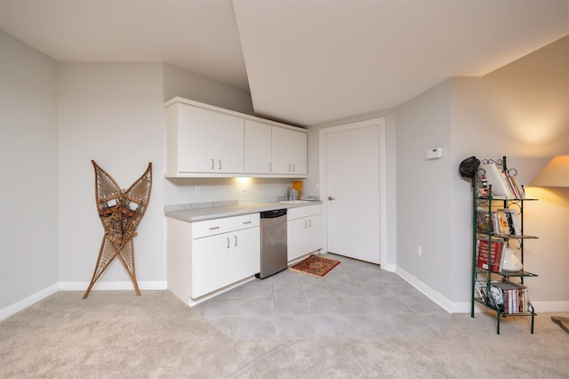 14943 Holcomb Ave, Clive, IA 50325 - kitchen featuring light countertops, white cabinets, and light carpet