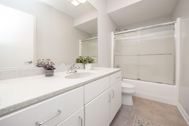 14943 Holcomb Ave, Clive, IA 50325 - bathroom featuring vanity, tile patterned floors, and shower / bath combination with glass door