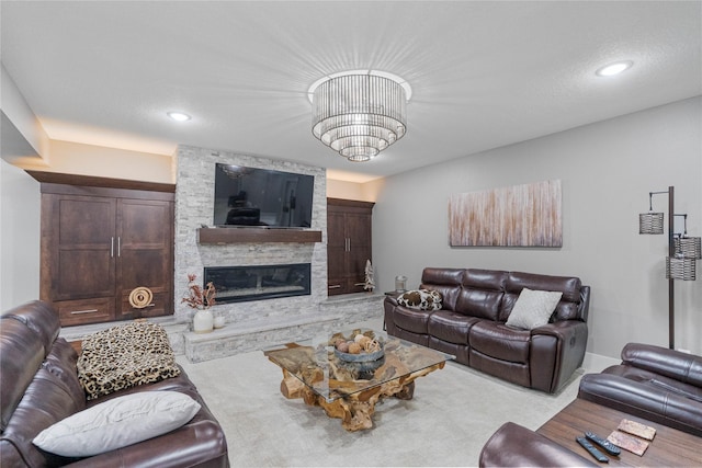 carpeted living area with a fireplace, a chandelier, and recessed lighting