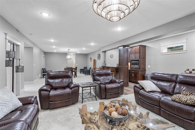 living area with a chandelier, recessed lighting, and light colored carpet
