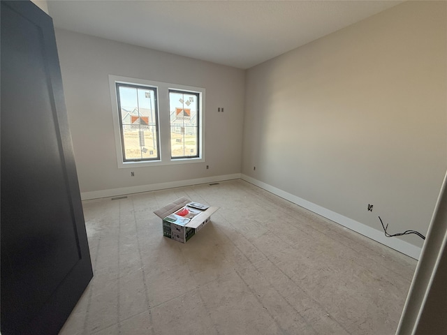 spare room featuring baseboards