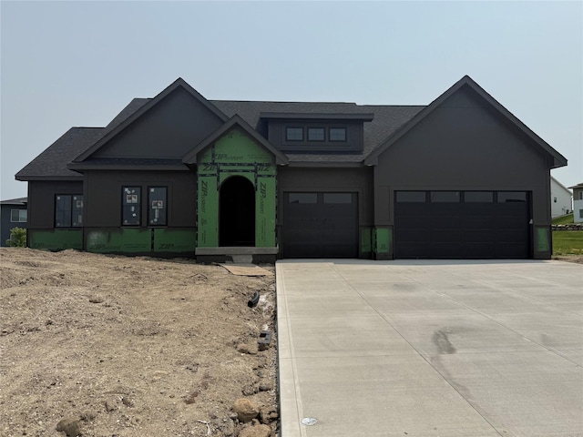 1128 NW 29th Ct, Grimes, IA 50111 - view of front facade with driveway, roof with shingles, stucco siding, and an attached garage