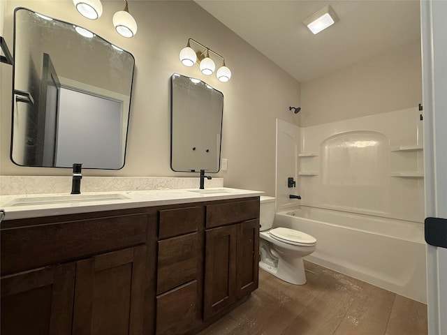 1128 NW 29th Ct, Grimes, IA 50111 - bathroom with wood finished floors, toilet, double vanity, and shower / washtub combination