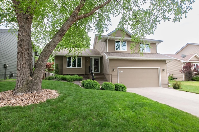 tri-level home with an attached garage, concrete driveway, and a front yard