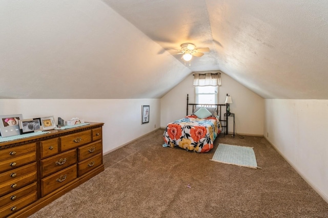 2322 E 39th St, Des Moines, IA 50317 - carpeted bedroom with lofted ceiling, ceiling fan, and a textured ceiling