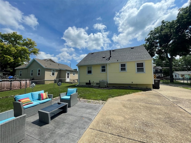 2322 E 39th St, Des Moines, IA 50317 - rear view of property featuring an outdoor living space, a patio area, and a shingled roof