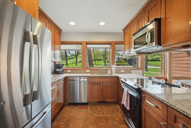6252 Panorama Dr, Panora, IA 50216 - kitchen featuring appliances with stainless steel finishes, a sink, brown cabinets, and recessed lighting