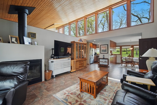 6252 Panorama Dr, Panora, IA 50216 - living room with wooden ceiling, a high ceiling, and dark stone finish floors