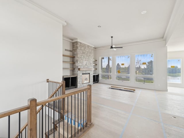 17406 Oakwood Dr, Urbandale, IA 50322 - unfurnished living room featuring crown molding, ceiling fan, a stone fireplace, and recessed lighting