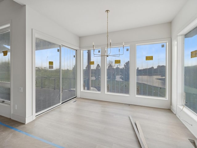 17406 Oakwood Dr, Urbandale, IA 50322 - unfurnished sunroom featuring a chandelier