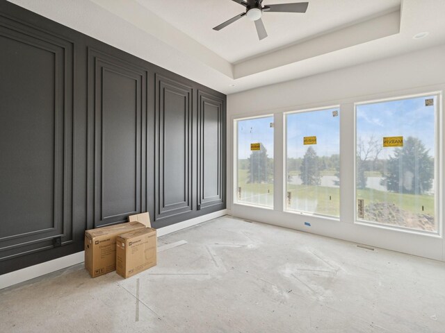 17406 Oakwood Dr, Urbandale, IA 50322 - spare room featuring ceiling fan and a tray ceiling
