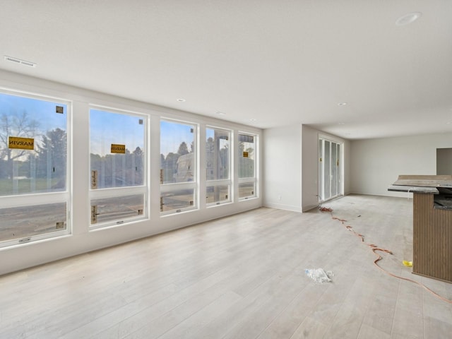 17406 Oakwood Dr, Urbandale, IA 50322 - unfurnished living room featuring light wood-style flooring