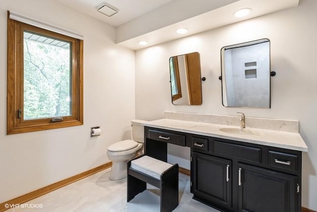 6406 Theresa Dr, Johnston, IA 50131 - bathroom with toilet, vanity, baseboards, and recessed lighting