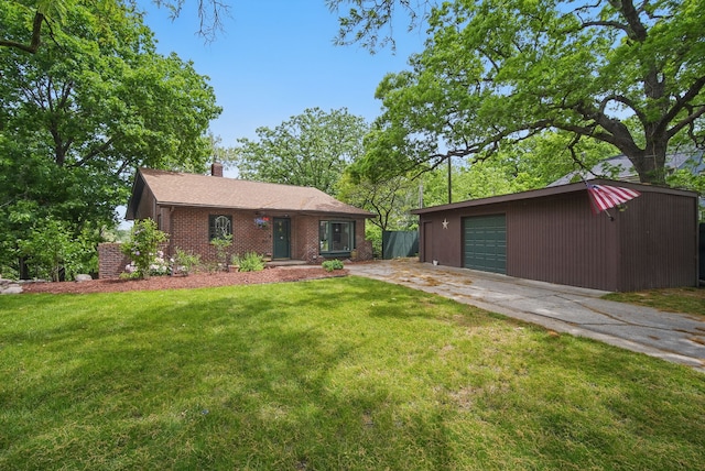 1919 Arlington Ave, Des Moines, IA 50314 - view of front facade featuring an outdoor structure, a front yard, brick siding, and concrete driveway