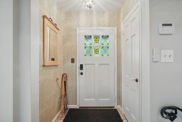 1919 Arlington Ave, Des Moines, IA 50314 - doorway with baseboards and a chandelier