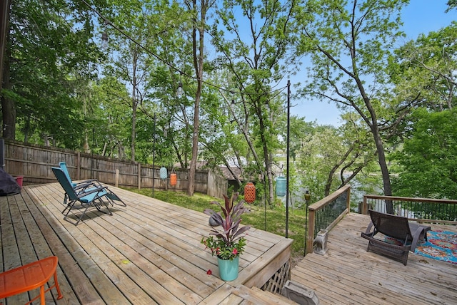 1919 Arlington Ave, Des Moines, IA 50314 - wooden terrace with a fenced backyard and view of wooded area