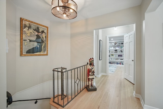 1919 Arlington Ave, Des Moines, IA 50314 - hallway with an upstairs landing, light wood-type flooring, and baseboards