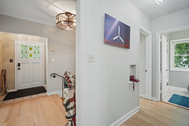 1919 Arlington Ave, Des Moines, IA 50314 - entrance foyer featuring light wood finished floors, baseboards, ornamental molding, and a chandelier