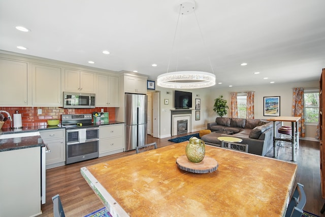 1919 Arlington Ave, Des Moines, IA 50314 - dining area with recessed lighting, wood finished floors, baseboards, and a fireplace