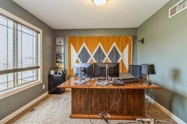 office area featuring plenty of natural light, baseboards, and carpet flooring