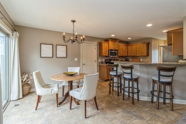 dining room with a chandelier, baseboards, and recessed lighting