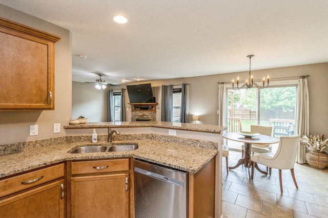 kitchen featuring dishwasher, a peninsula, a sink, brown cabinetry, and recessed lighting