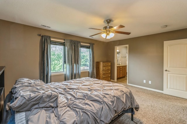 bedroom featuring carpet floors, baseboards, a ceiling fan, and connected bathroom