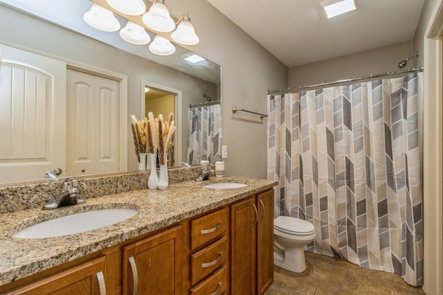 bathroom with toilet, double vanity, and a shower with curtain