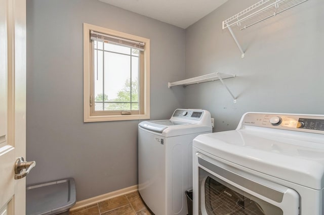 washroom featuring washing machine and clothes dryer and baseboards