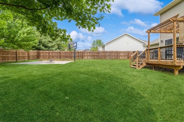 view of yard with a wooden deck, an outdoor fire pit, and a patio area