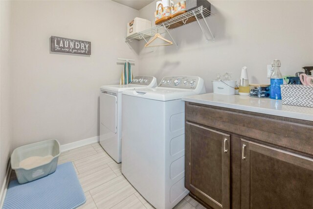 217 NE Glendale Ln, Ankeny, IA 50021 - laundry area featuring washing machine and dryer, cabinet space, baseboards, and light tile patterned flooring