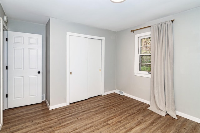 4014 Aplin Rd, Ames, IA 50014 - unfurnished bedroom featuring wood finished floors, baseboards, and a closet