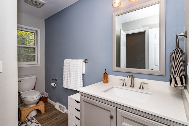 4014 Aplin Rd, Ames, IA 50014 - bathroom featuring toilet, wood finished floors, vanity, and baseboards