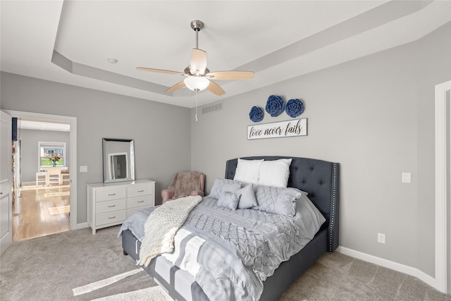 913 SE Trail Ridge Rd, Grimes, IA 50111 - carpeted bedroom featuring baseboards, a ceiling fan, and a tray ceiling