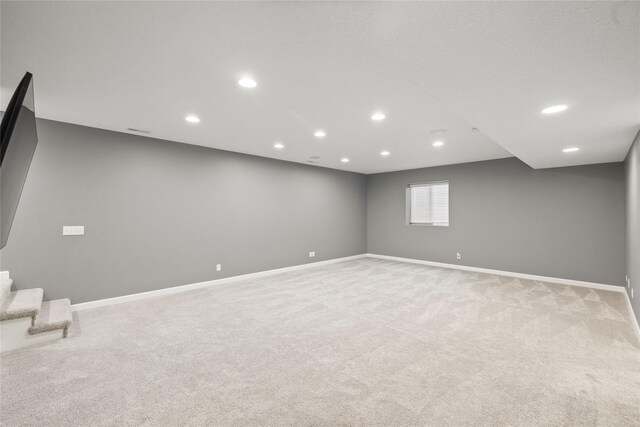 913 SE Trail Ridge Rd, Grimes, IA 50111 - below grade area with light colored carpet, baseboards, recessed lighting, and stairs