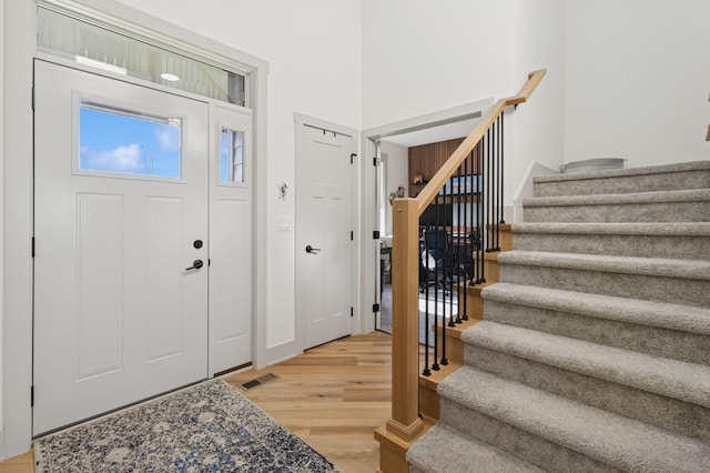 585 NW Rosemont Dr, Waukee, IA 50263 - entryway featuring stairs and light wood-type flooring