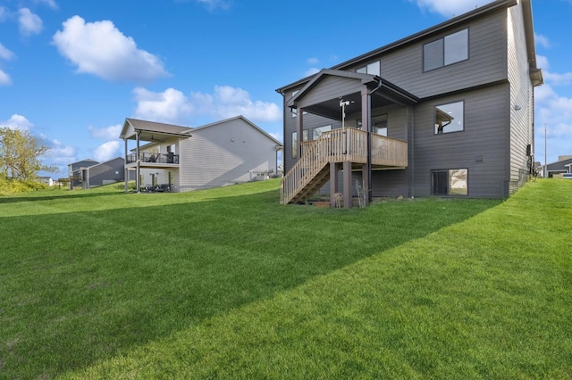 585 NW Rosemont Dr, Waukee, IA 50263 - back of property with stairway, a yard, and a wooden deck