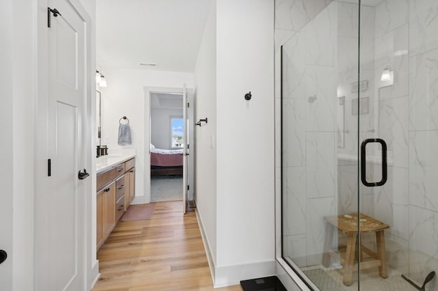 585 NW Rosemont Dr, Waukee, IA 50263 - ensuite bathroom featuring a marble finish shower, wood finished floors, and vanity