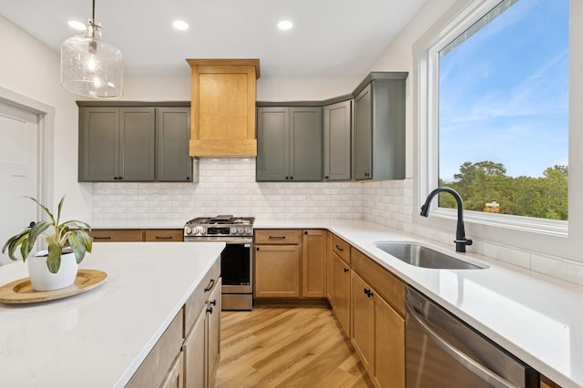 585 NW Rosemont Dr, Waukee, IA 50263 - kitchen featuring appliances with stainless steel finishes, plenty of natural light, light wood-style flooring, light countertops, and recessed lighting