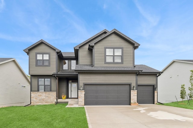 585 NW Rosemont Dr, Waukee, IA 50263 - view of front of house featuring driveway, a front lawn, stone siding, a garage, and roof with shingles