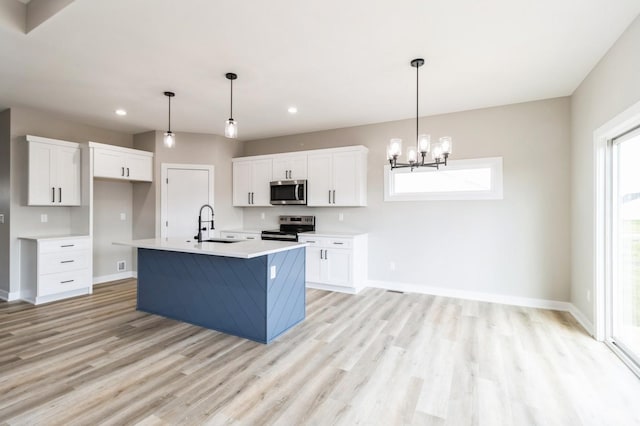 14512 Northpark Dr, Urbandale, IA 50111 - kitchen featuring stainless steel appliances, light wood-style flooring, white cabinetry, light countertops, and recessed lighting