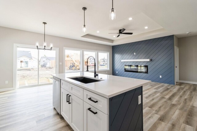 14512 Northpark Dr, Urbandale, IA 50111 - kitchen with a sink, light wood-type flooring, a raised ceiling, stainless steel dishwasher, and recessed lighting