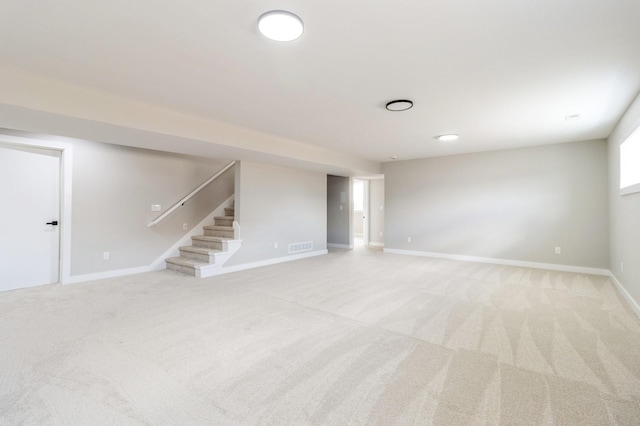 14512 Northpark Dr, Urbandale, IA 50111 - basement with light carpet, stairway, and baseboards