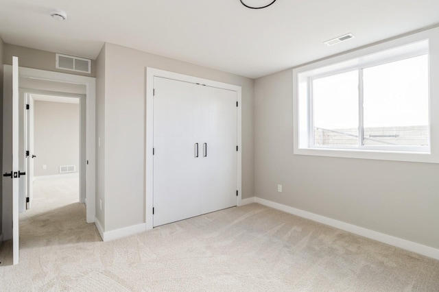 14512 Northpark Dr, Urbandale, IA 50111 - unfurnished bedroom featuring light carpet, baseboards, and a closet