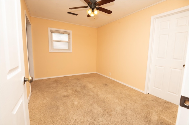 101 E Cronkhite St, Knoxville, IA 50138 - unfurnished bedroom featuring carpet floors, ornamental molding, baseboards, and a ceiling fan